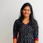 girl wearing a kurta is standing and smiling