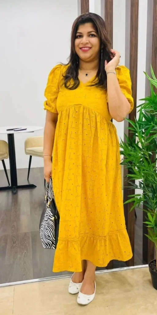 model smiles and poses in dress made by fashion designer in kochi