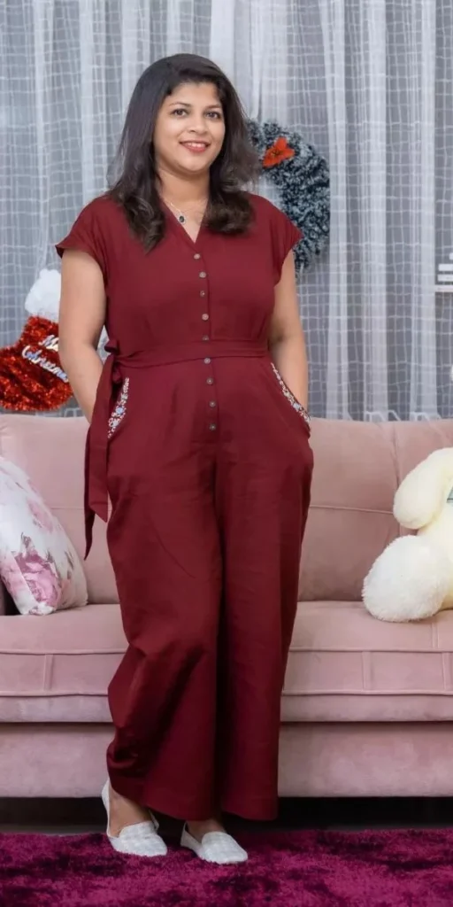 model smiles and poses in jumpsuit made by fashion designer in kochi