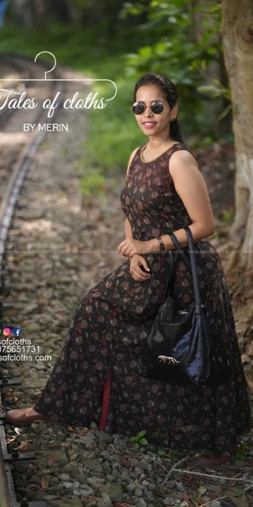 model smiles and poses in dress made by fashion designer in kochi