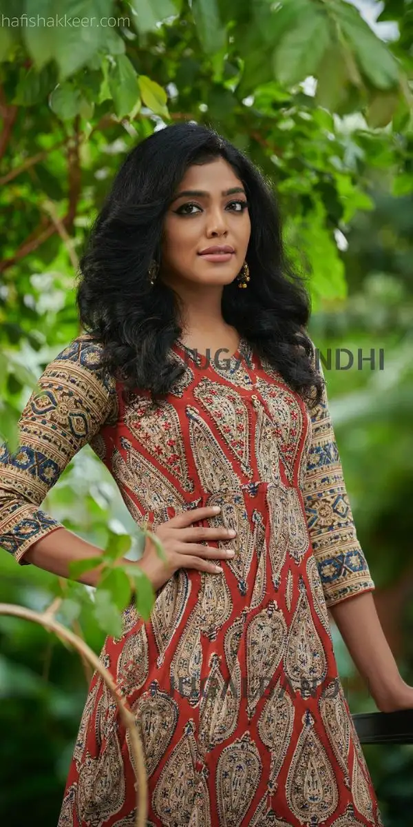 actress standing wearing an anarkali made by the fashion designer in Kochi.