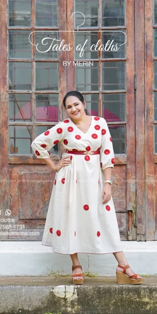 model smiles and poses in dress made by fashion designer in kochi
