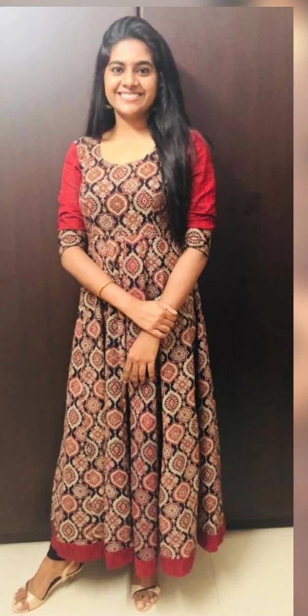 actress standing wearing an anarkali made by the fashion designer in Kochi.