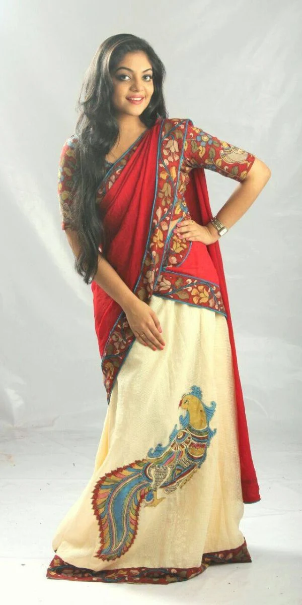 actress smiling and standing wearing an anarkali made by a fashion designer in Kochi.