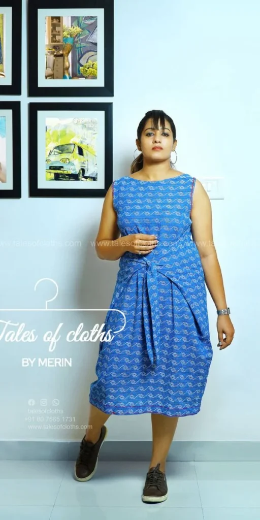 model smiles and poses in dress made by fashion designer in kochi