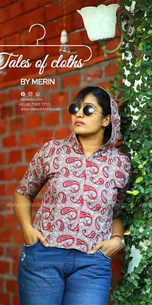 model smiles and poses in hoodie top made by fashion designer in kochi