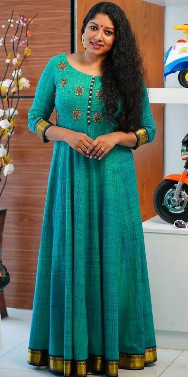 actress standing wearing an anarkali made by the fashion designer in Kochi.
