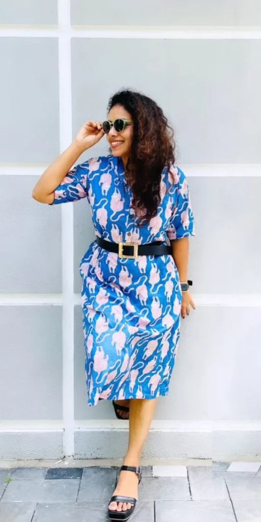 model smiles and poses in dress made by fashion designer in kochi