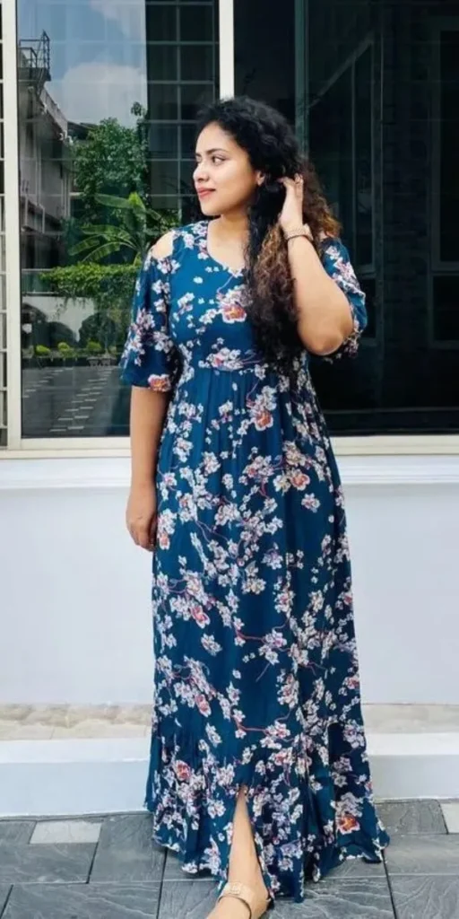 model smiles and poses in dress made by fashion designer in kochi